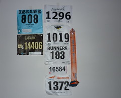 Race number bibs tacked up on the wall