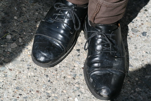 Well worn black lace ups complete the ensemble.