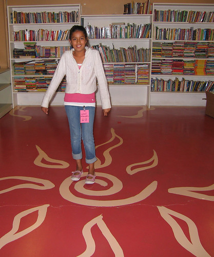 Goodwill Ambassador Laura proudly showing the library.
