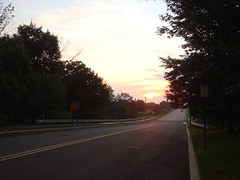 sunset at the end of the long and narrow road