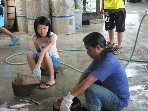 Lead actress Fei Ling taking lessons in cutting salted fish