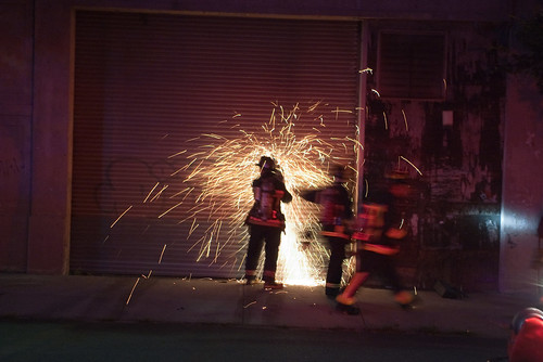 Firefighters use a saw to open a door for access