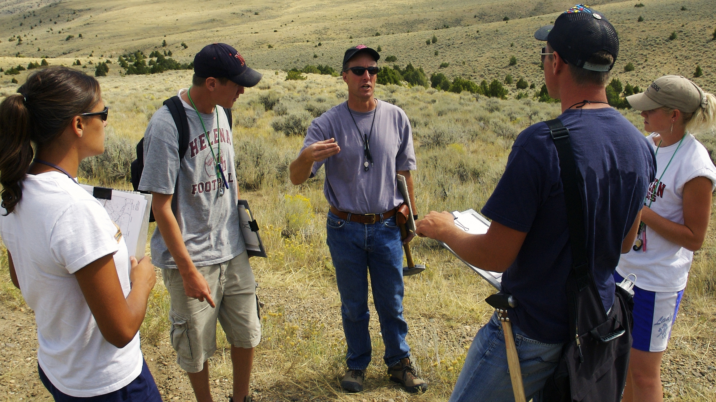 Professor Rob Thomas visiting with students in the field
