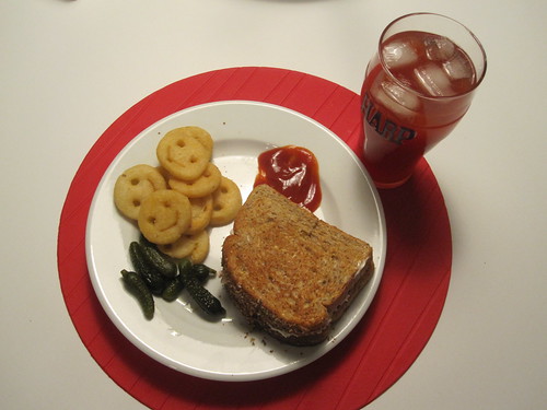 Tuna sandwich, smiles, pickles, tomato juice