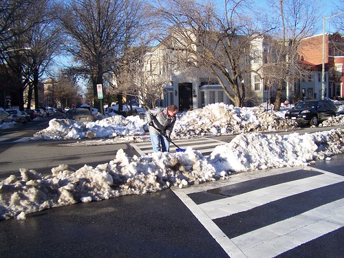A committed resident clearing the crosswalk median on his block
