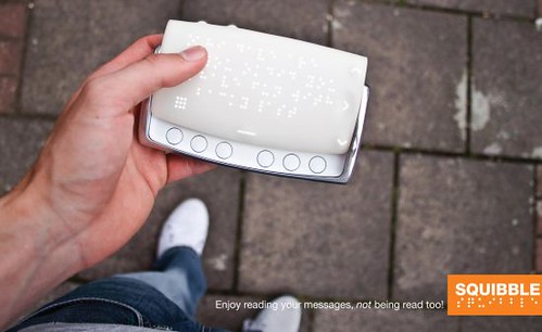 photo of large pocket-sized electronic device with a braille display and a series of buttons. Captioned Enjoy reading your messages, not being read to!