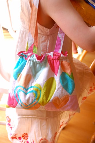 little girl holding fabric purse