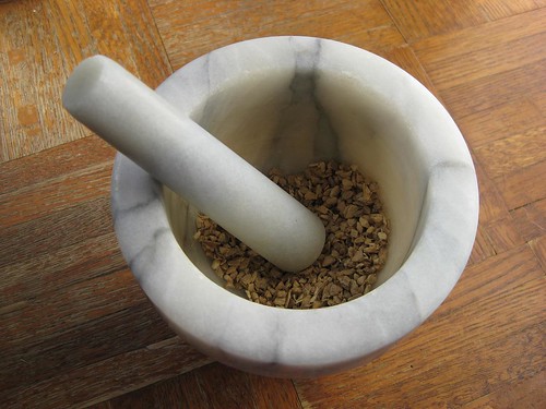 cracked ginger in a mortar and pestle