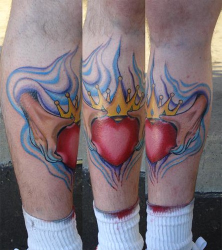 Claddagh tattoo ands holding heart