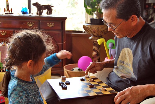 a game of checkers with her Lolo