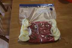 Pork with spices onions and apples in a Ziploc handi-vac bag.