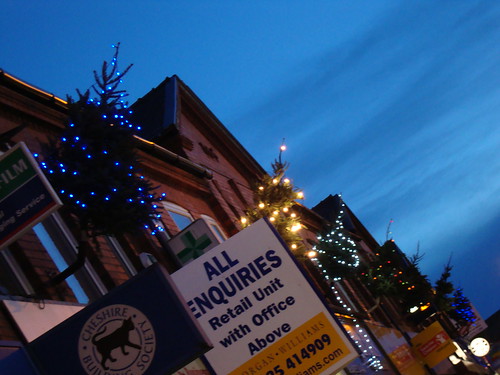 Christmas trees in flag poles in Stockton Heath
