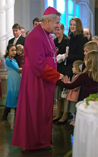 Archbishop Robert Carlson meeting children, at Saint Francis de Sales Oratory, in Saint Louis, Missouri, USA
