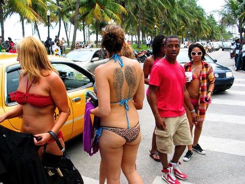 American Girl in thong bikini showing tattoos