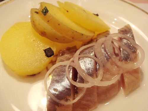 Russian salt-cured Herring, raw onion rings and new potatoes