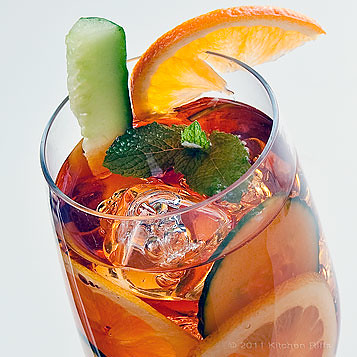Pimm's Cup garnished with Cucumber, Lemons, and Orange