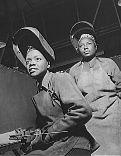 Two African-American women working in a factory during WWII.