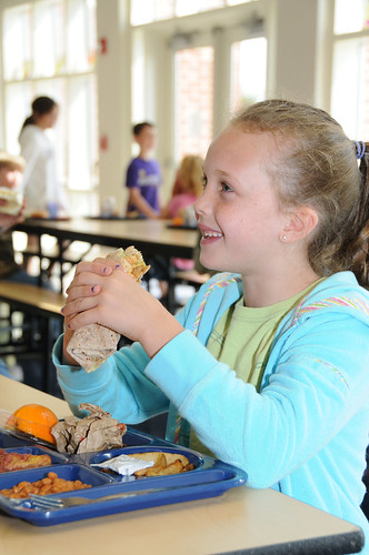 Ryvers, a Mount Lebanon Elementary School student, enjoys a Crunchy Hawaiian Chicken Wrap, her school's entry for the First Lady’s Recipes for Healthy Kids Challenge.  