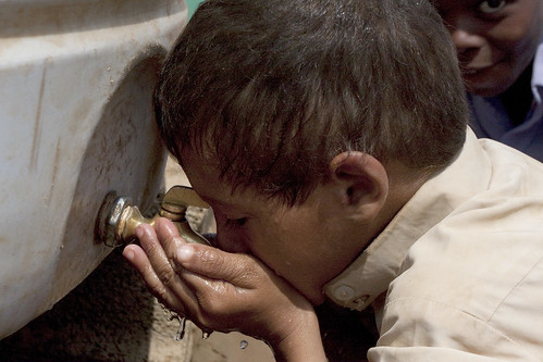 圖片為葉門哈傑省的一個小男孩正在水箱取水喝 攝影Paul Stephens/IRIN