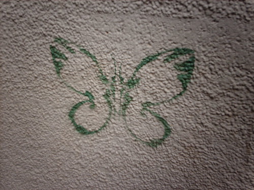 stencil graffiti of a green butterfly