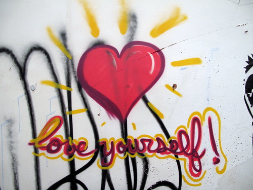 graffiti: big red heart with the words "love yourself!" in cursive, written underneath