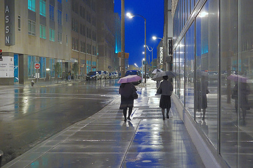 Downtown Saint Louis, Missouri, USA - pedestrians at dusk in the rain