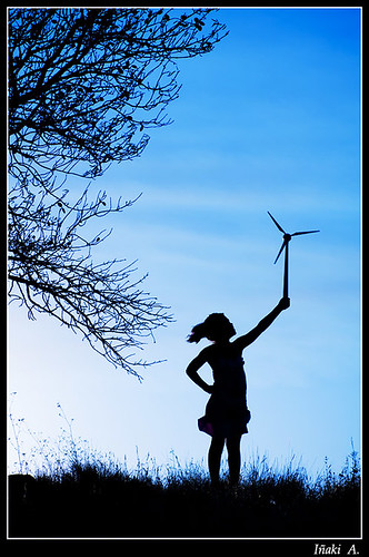 Child holding up a small wind turbine.