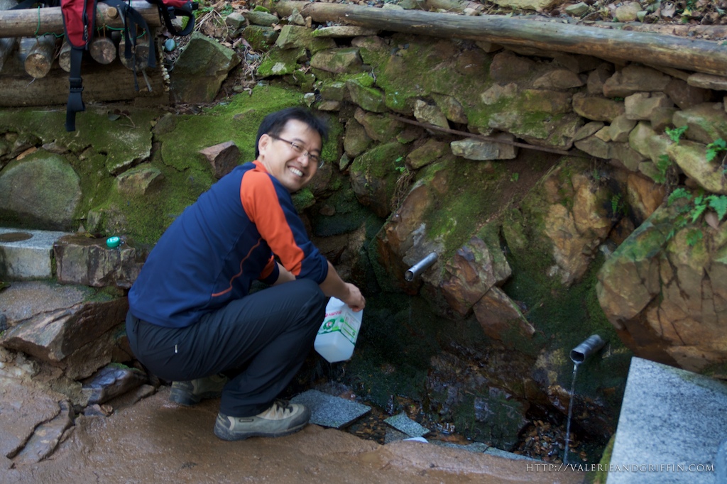 Mr. Choi getting water from the spring at the top of the mountain.