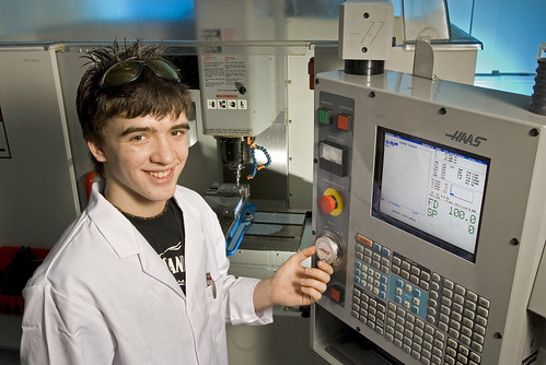 Apprentice using a HAAS CNC mini-mill machine.