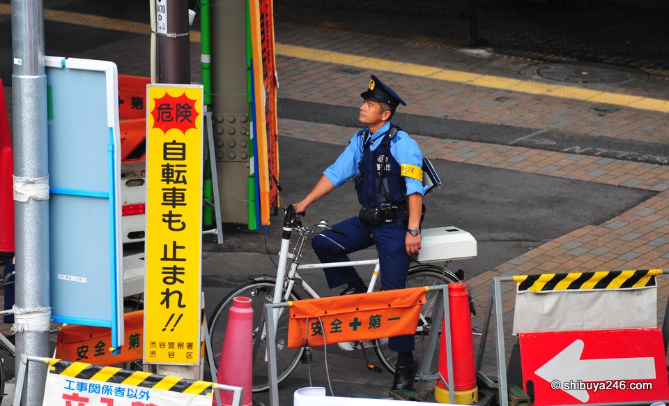 A policeman contemplating his ride home. Maybe he is looking up at Horikita Maki
