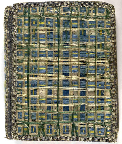 17th century satin embroidered book cover with threads of coloured silk 'woven' across upper and lower covers.