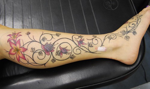 lilys, orchids and vines tattoo on leg and foot