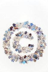 Copyright sign made of jigsaw puzzle pieces separated