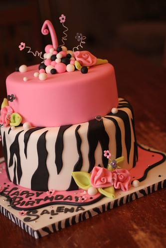 black and white zebra print background. Hot pink and Zebra print cake