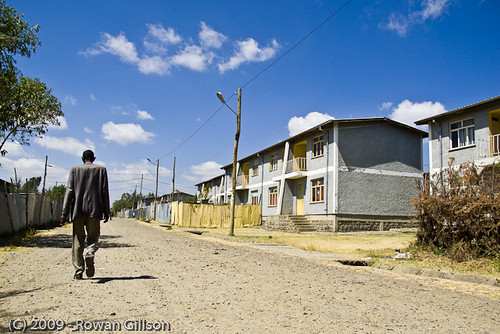 An Ethiopian man walks down the street through a wealthy part of Addis Ababa..