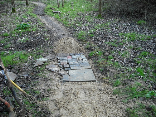 Using concrete slabs and bricks to reinforce trail.