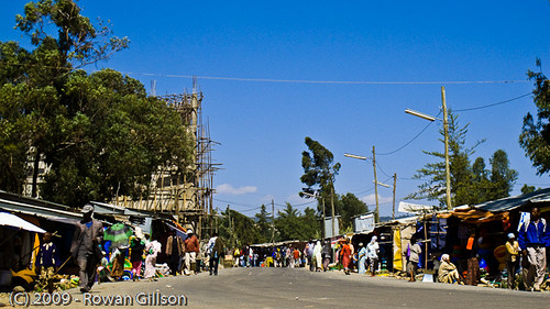 Shoppers and merchants line the side of the road in a market area of Addis Ababa, Ethiopia..