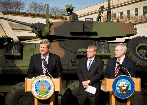 Secretary Vilsack, Congressman McIntire and Secretary Mabus answer reporters questions while standing in front of a light assault vehicle of the type capable to accommodate fuel from renewable sources. 