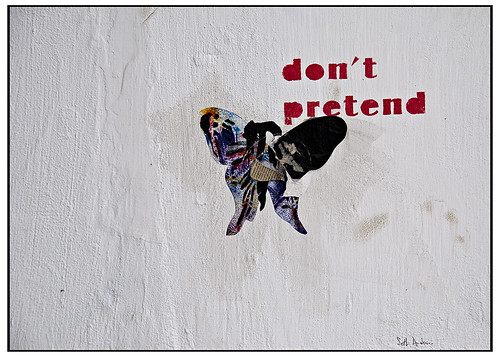 scrapbooked graffiti -- a newspaper butterfly with the words 'don't pretend' up over the right wing