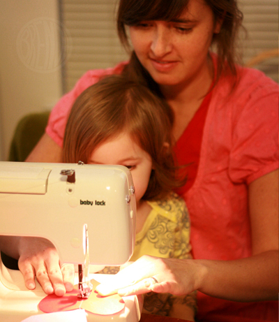mother sewing with a child 