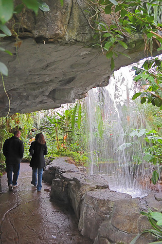 Waterfall with visitors in Climatron, at Missouri Botanical Garden (Shaw's Garden), in Saint Louis, Missouri, USA