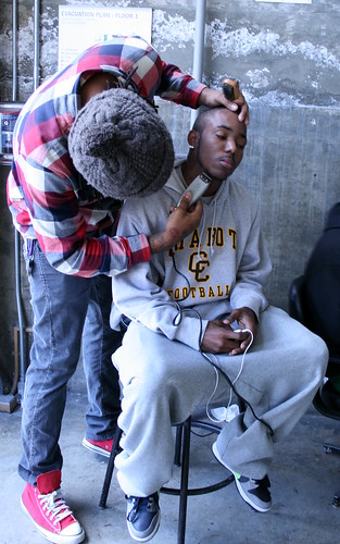 Laney College student receives haircut in the Laney Theater Lobby