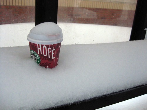 Abandoned Lipstick-Stained Starbucks Cup in Bus Stop Bench Snowdrift