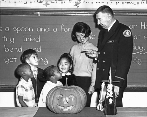 Firefighter G.F. Sevilles visiting classroom at Halloween, 1966