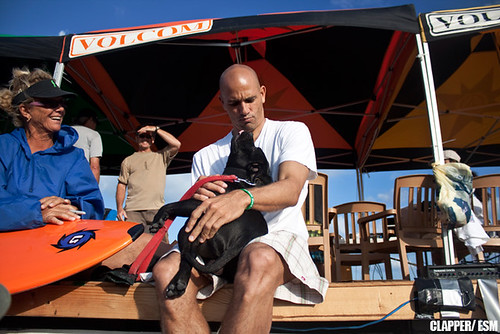 Kelly Slater gets cuddly with this dog at the Slater Invitational (photo:©Ryan Clapper ESM)