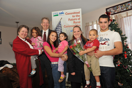 Deputy Secretary Merrigan, Director Williams and the Hench Family in their new home