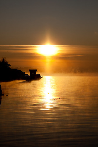 Sun rising over smoky water in Norway