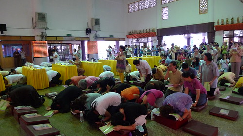 People bowing during Buddhist ceremony