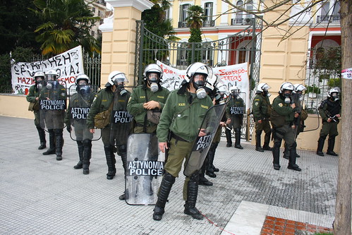 Greek riot police confront protesters outside government building