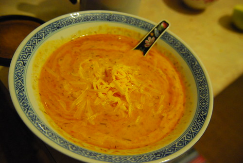 Roasted red pepper tomato soup with a swirl of goat yogurt and cheddar cheese
